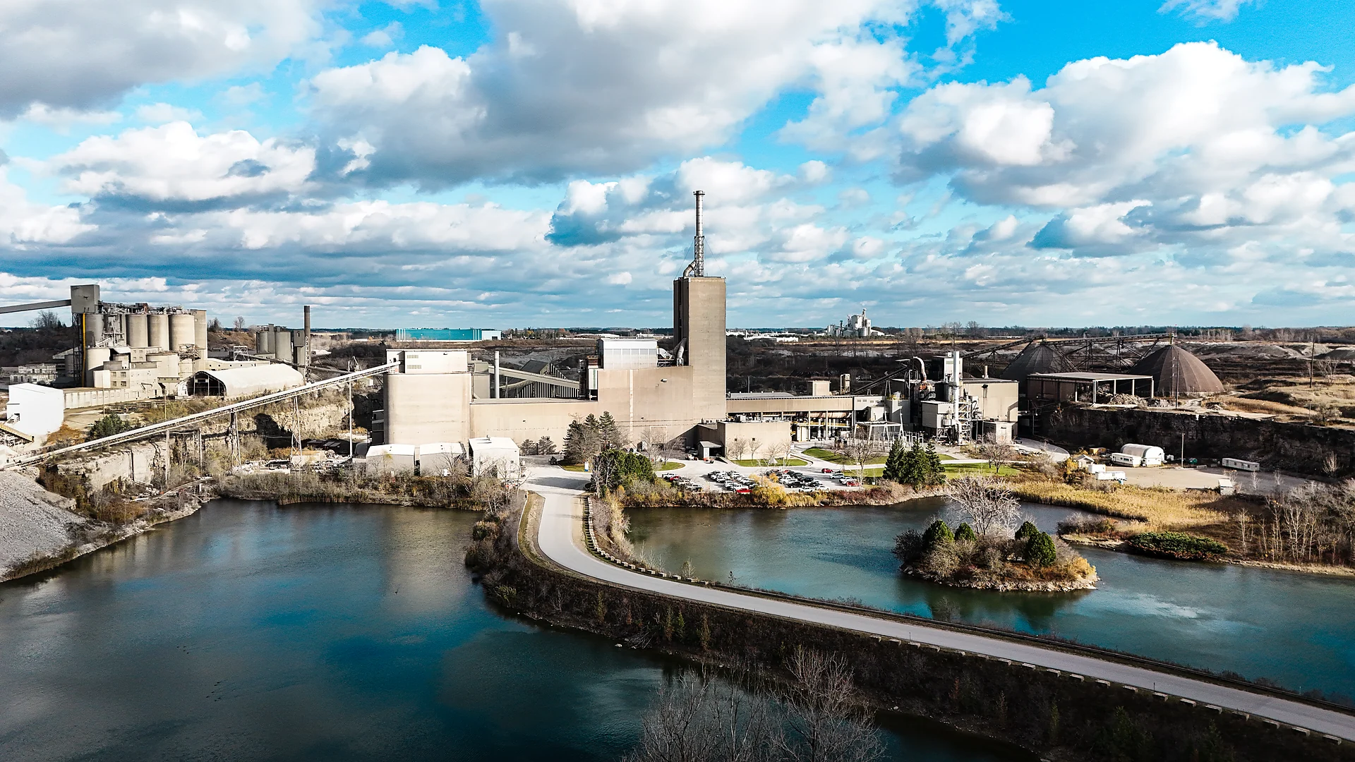 Building Materials Supplier - cement plant beside a quarry lake with a causeway road
