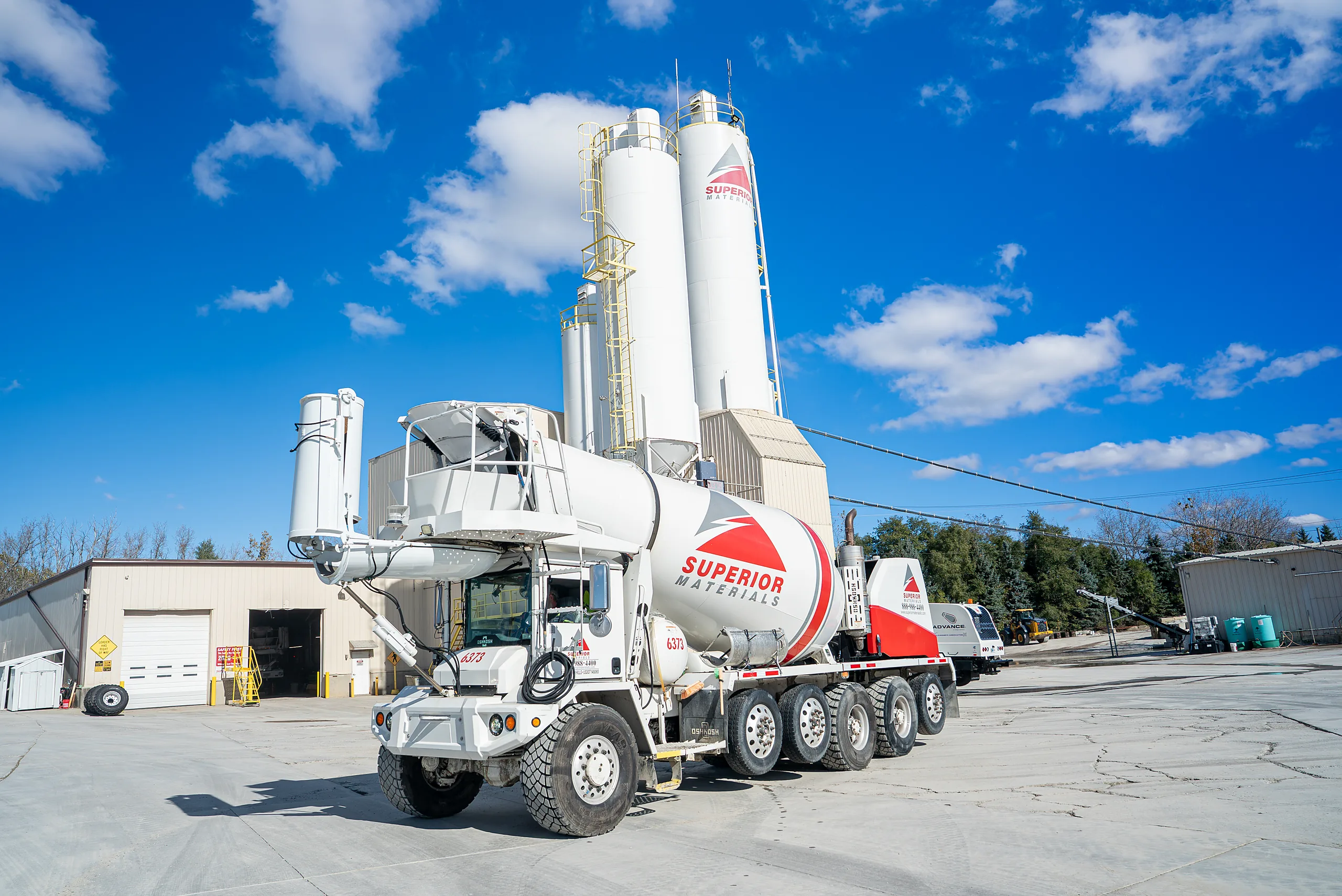 Building Materials Supplier - Superior Materials mixer truck at a plant with cement silos