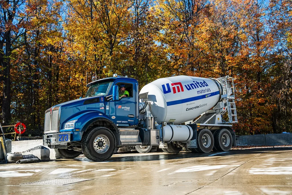 Regional Cement Suppliers - United Materials mixer truck on a job site surrounded by autumn trees