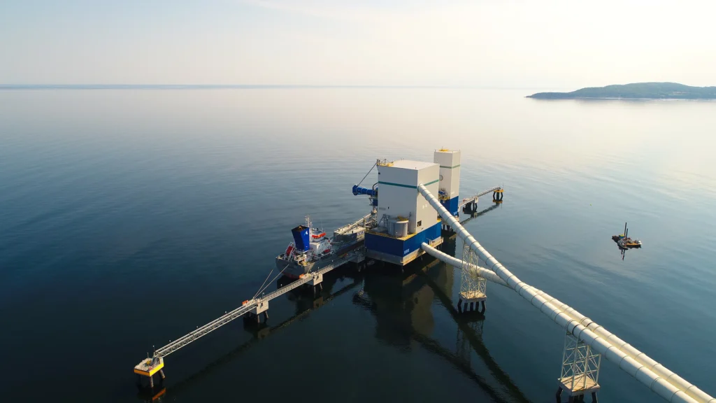 Seven Pillars of Sustainability - aerial view of a cement marine terminal and loading pier on calm water